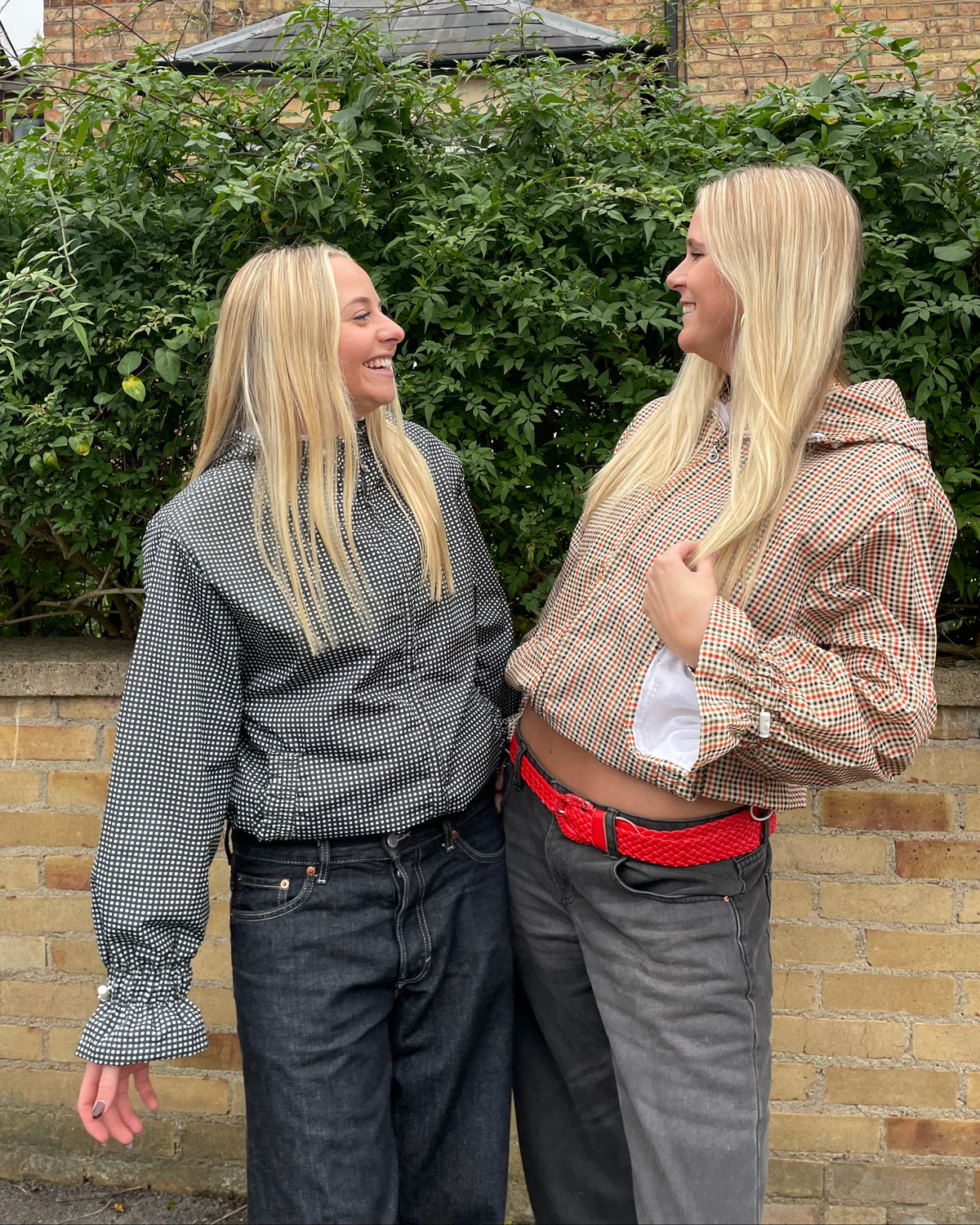 2 women wearing flared windbreakers