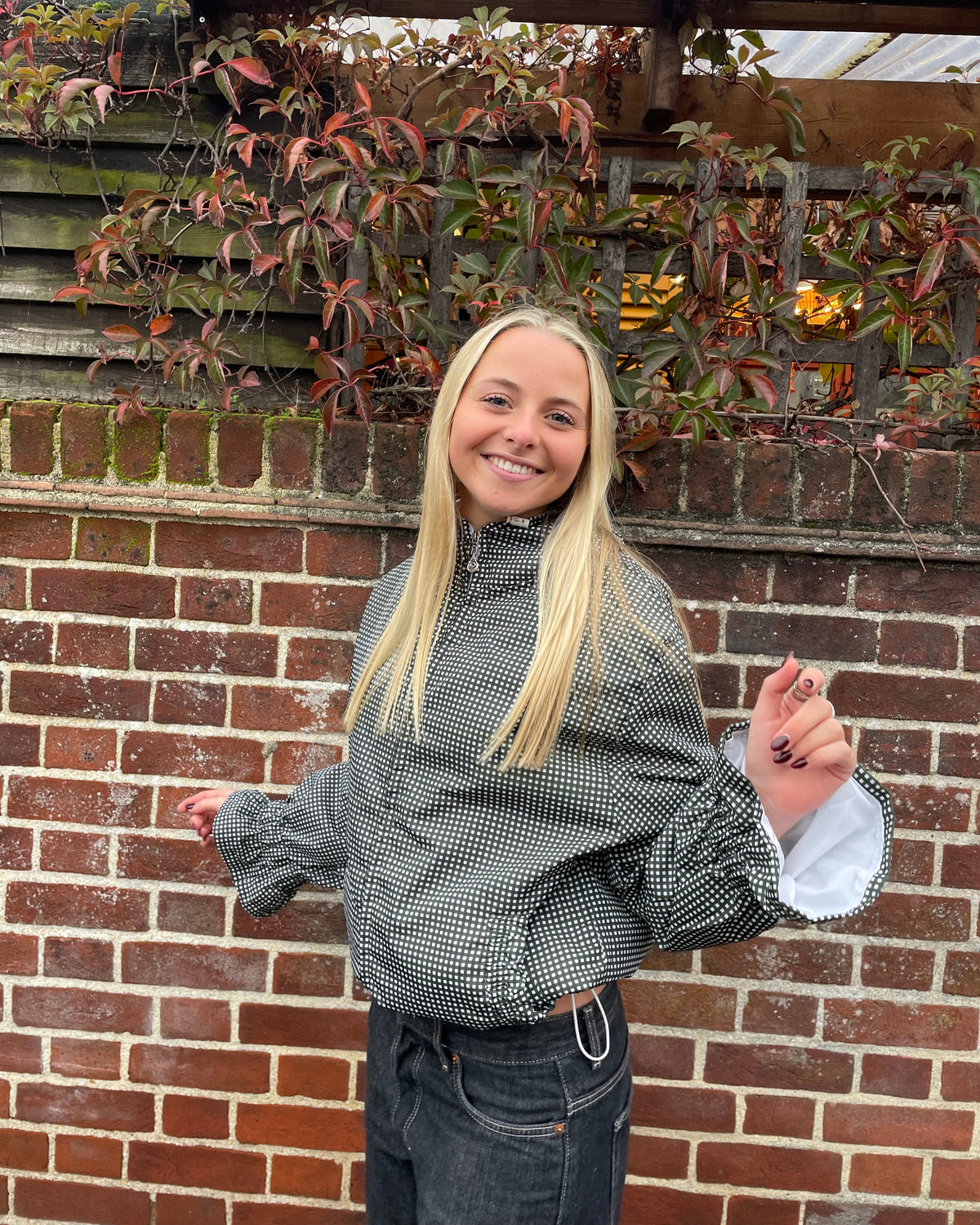 woman wearing a olive gingham flared windbreaker