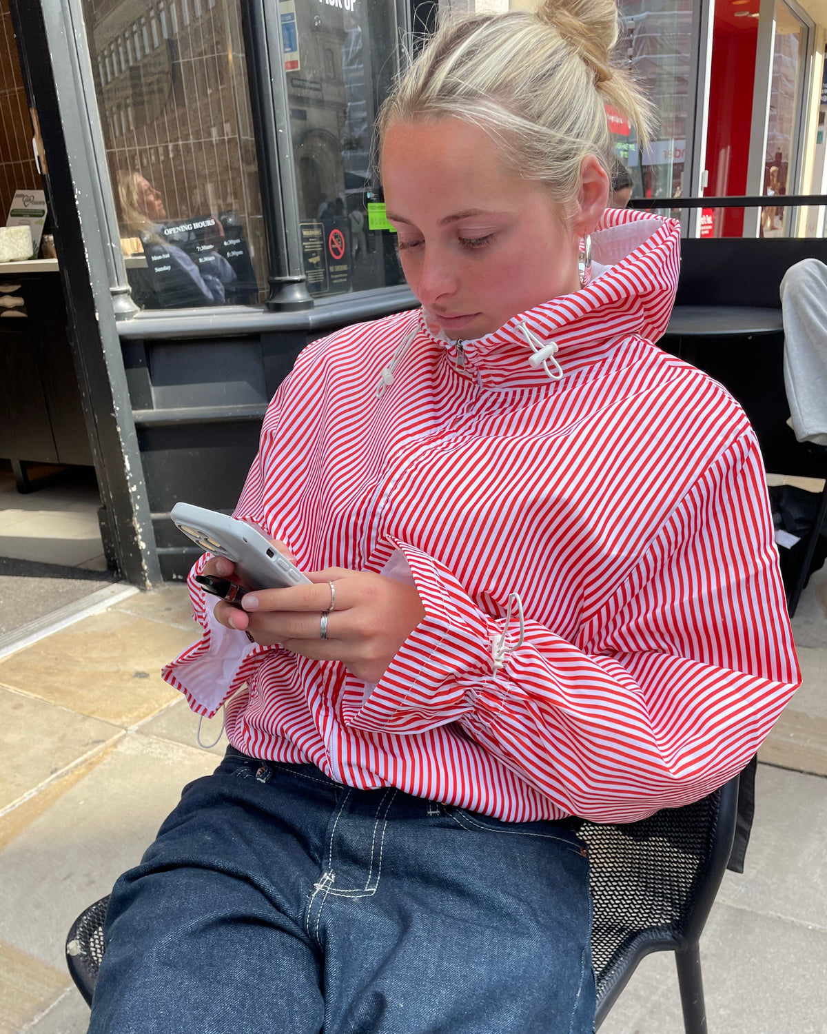 Person wearing a red and white striped shirt in a store setting
